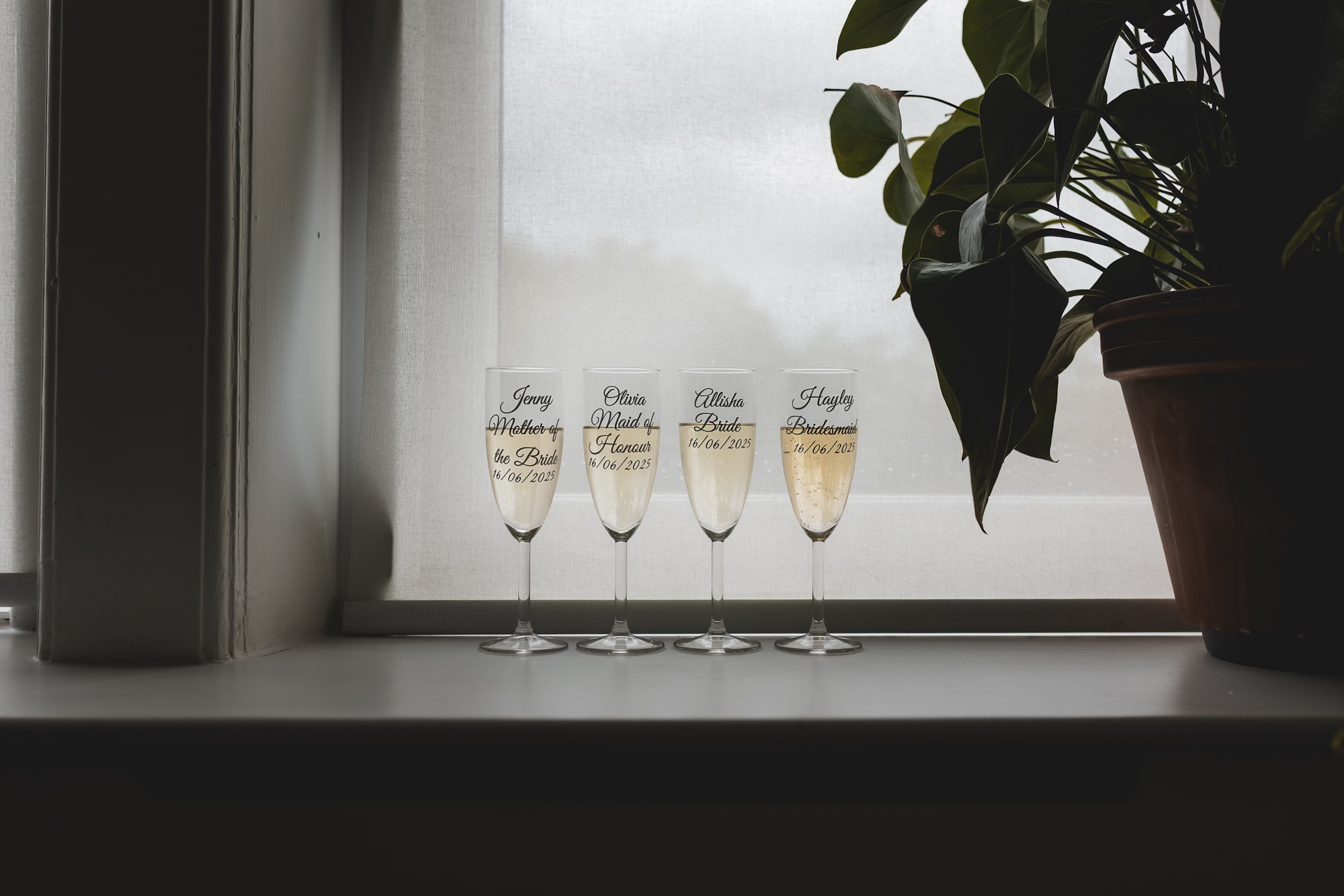 Personalised bridal party champagne glasses during Yorkshire wedding morning preparations