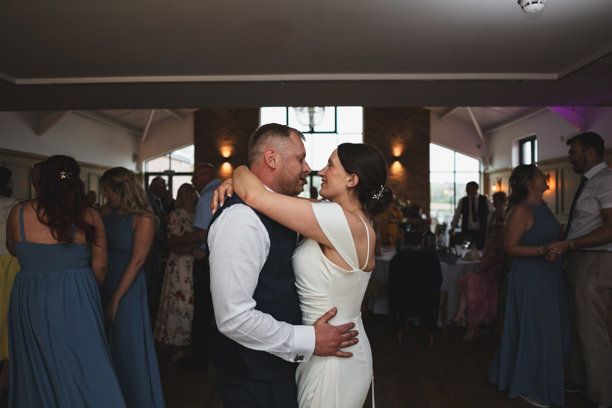 Bride and groom sharing first dance during relaxed documentary wedding reception at Yorkshire wedding venue