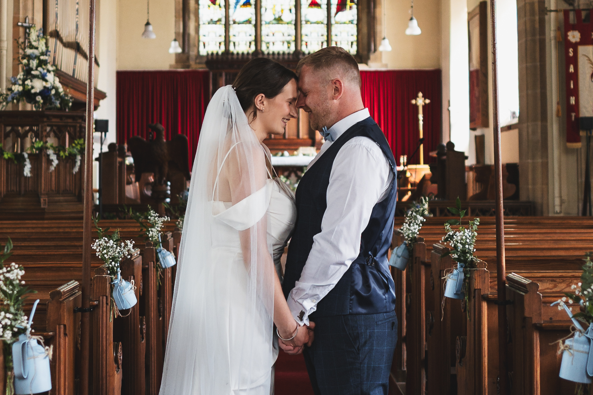 Documentary wedding photographer capturing intimate bride and groom portrait inside church ceremony venue in Yorkshire UK