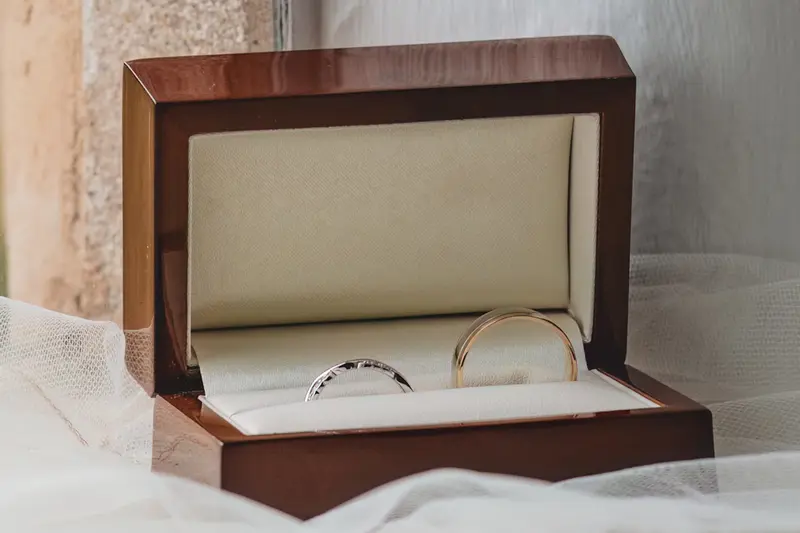 Close up wedding detail of rings in a wooden box before the ceremony