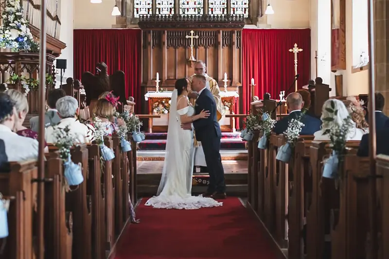 First kiss during romantic church wedding ceremony in Yorkshire