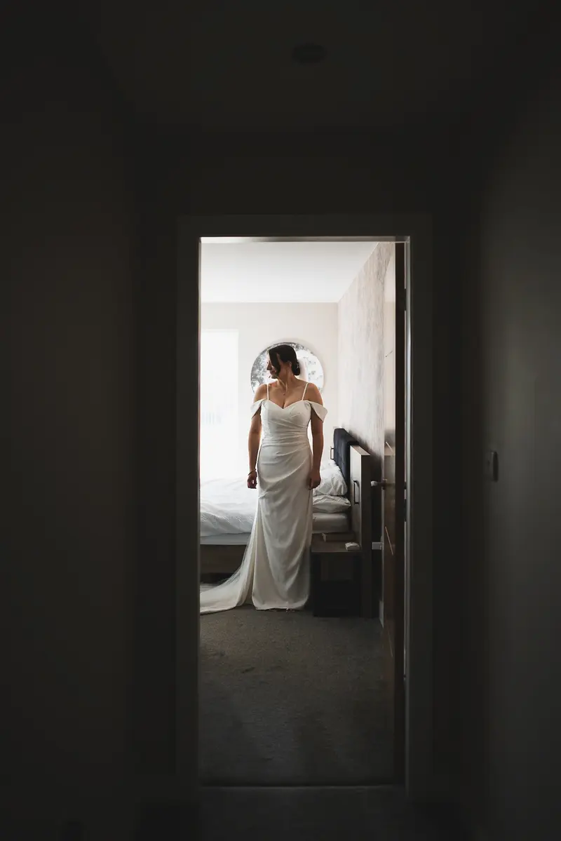 Bride walking through hallway before wedding ceremony