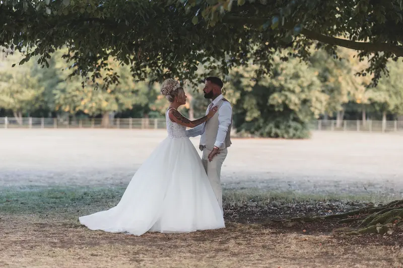 Romantic newlywed portrait under tree, natural wedding couple photography, cinematic wedding photographer