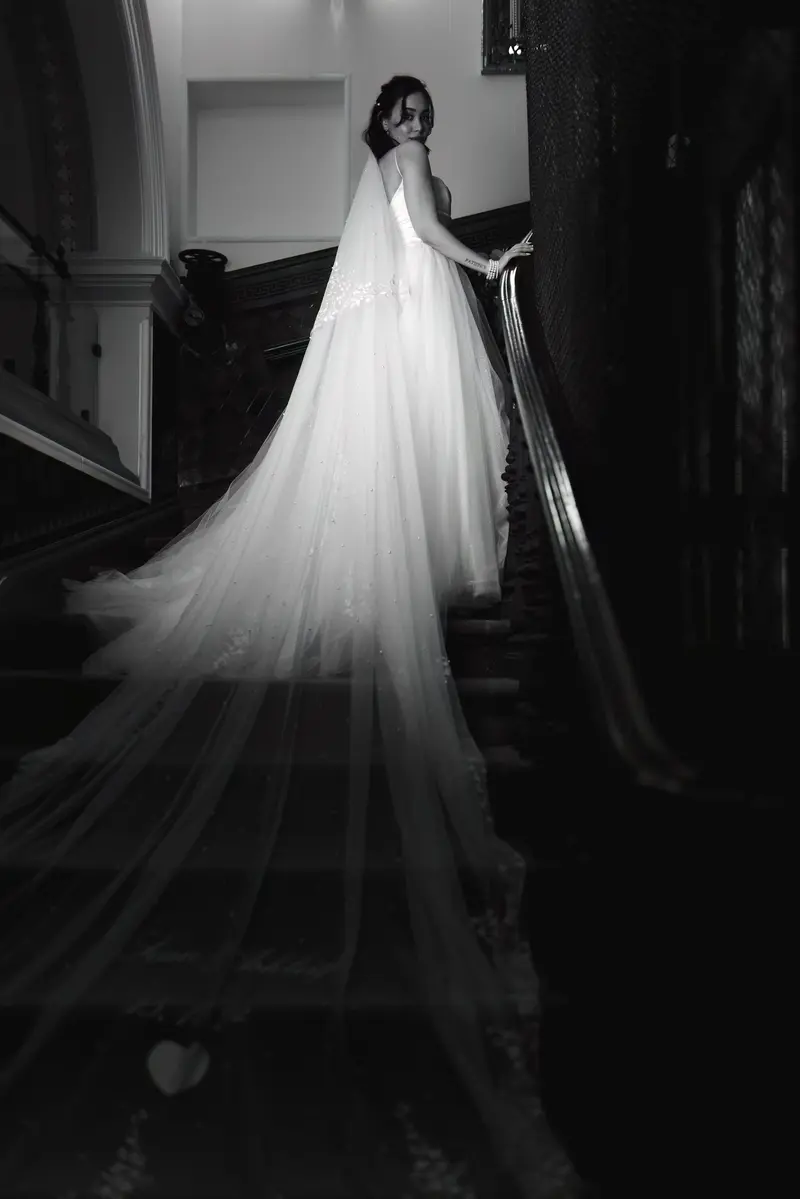 Elegant bride portrait with long veil on staircase, luxury wedding photography Liverpool