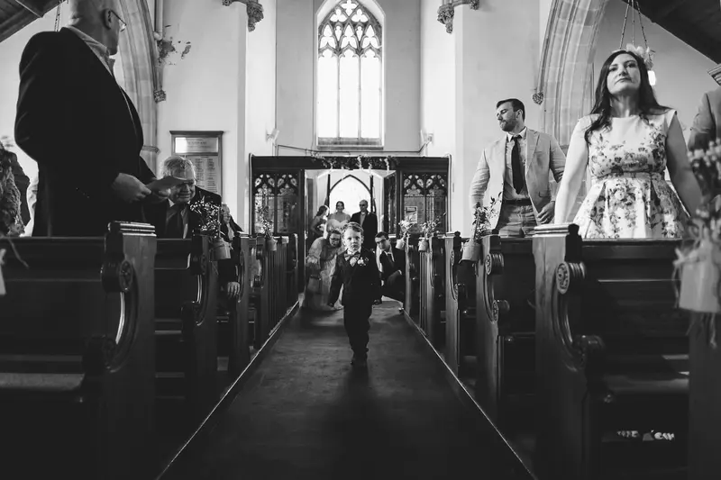 Cinematic church aisle entrance during Yorkshire wedding ceremony
