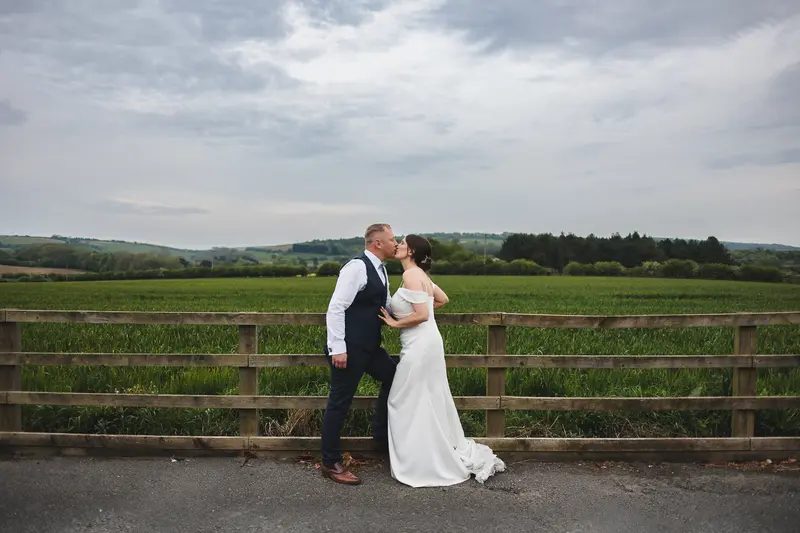 Outdoor Yorkshire wedding kiss photo with dramatic cloudy sky