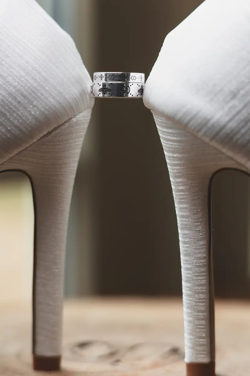 Wedding rings between bridal heels, creative wedding detail photography, Leeds wedding photographer