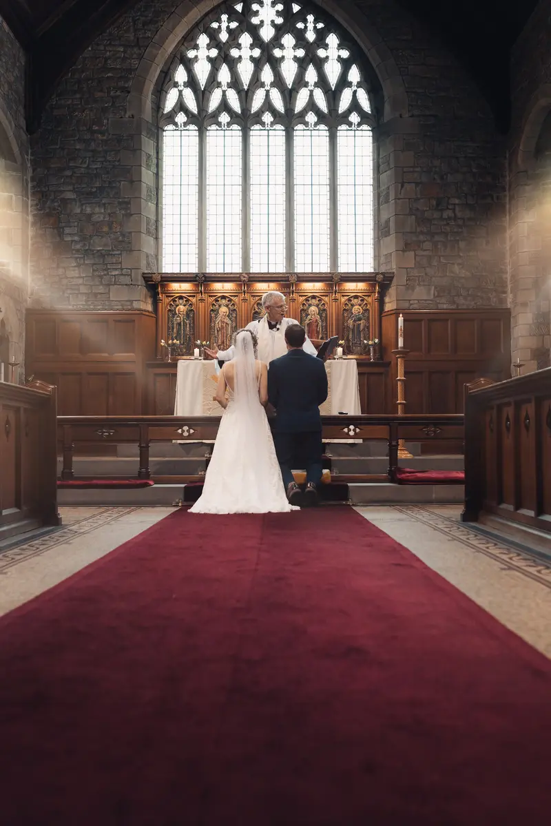Moody church wedding ceremony photograph with dramatic cathedral light in Yorkshire