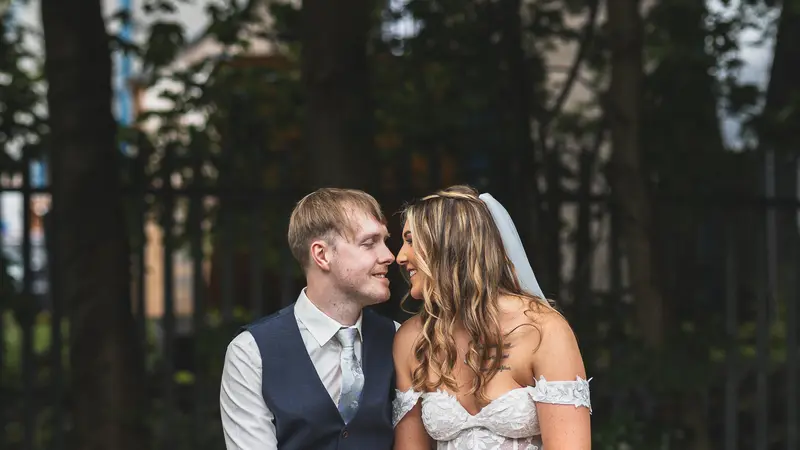 Bride and groom sharing a romantic kiss during cinematic wedding portraits