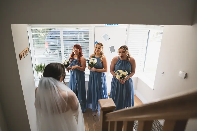 Emotional bridesmaids reaction seeing the bride before ceremony