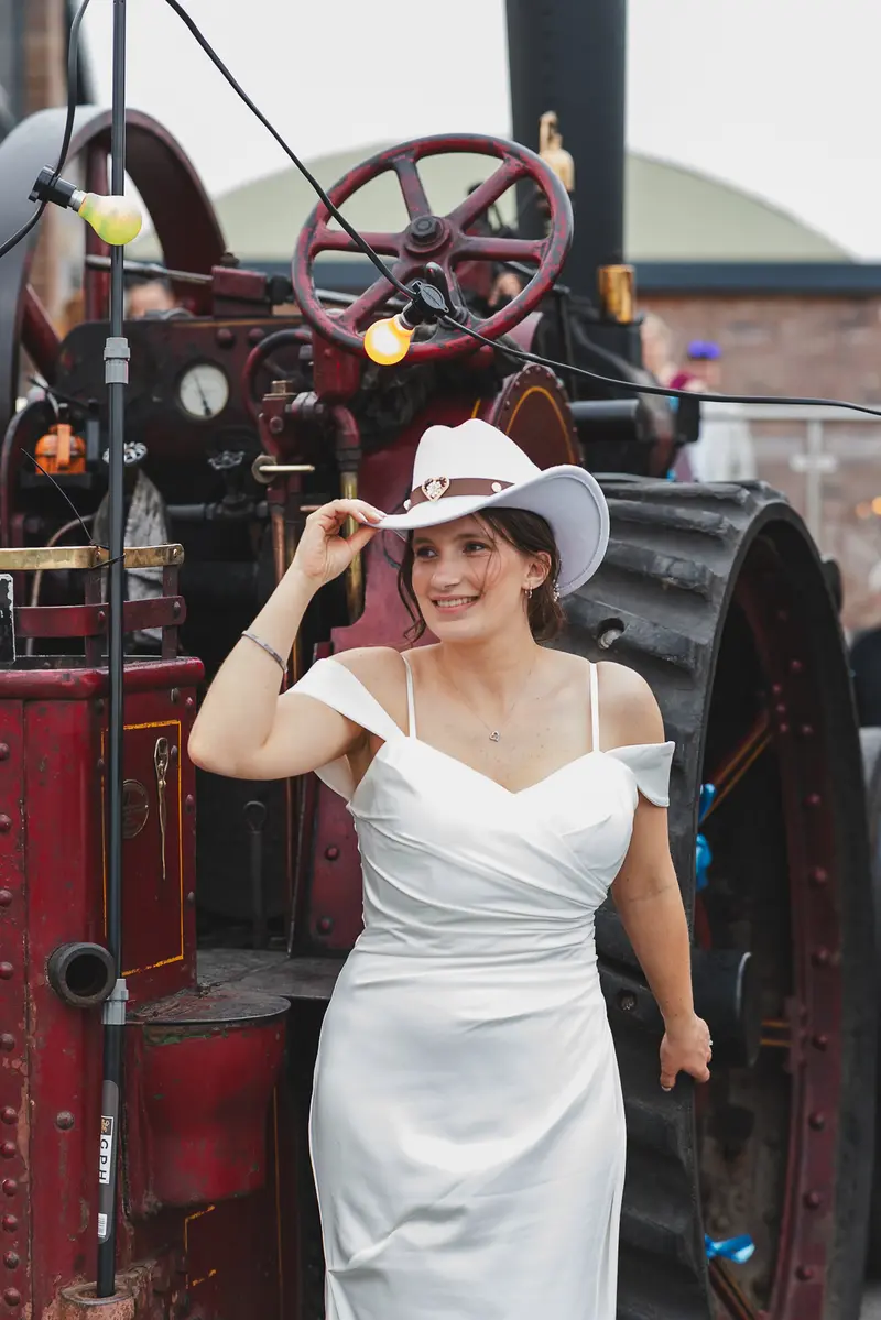 Cinematic bridal portrait with rustic wedding fairground backdrop