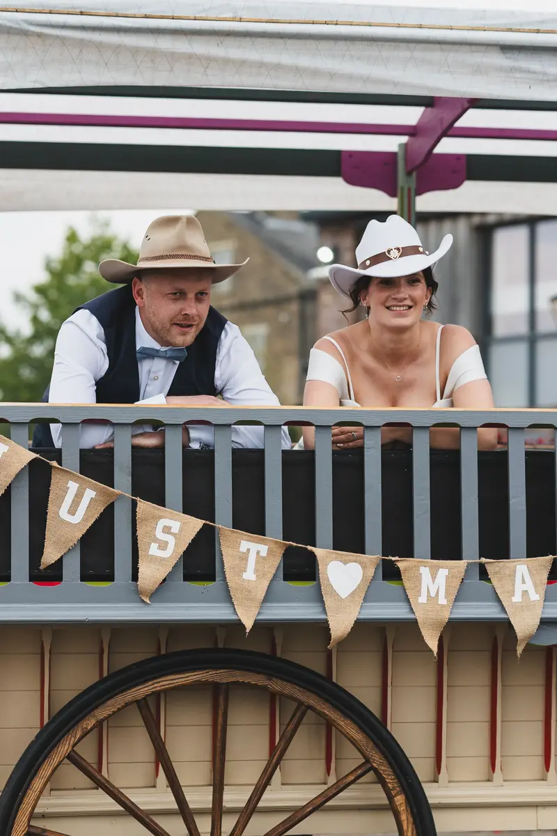Relaxed wedding couple portrait on vintage wagon ride