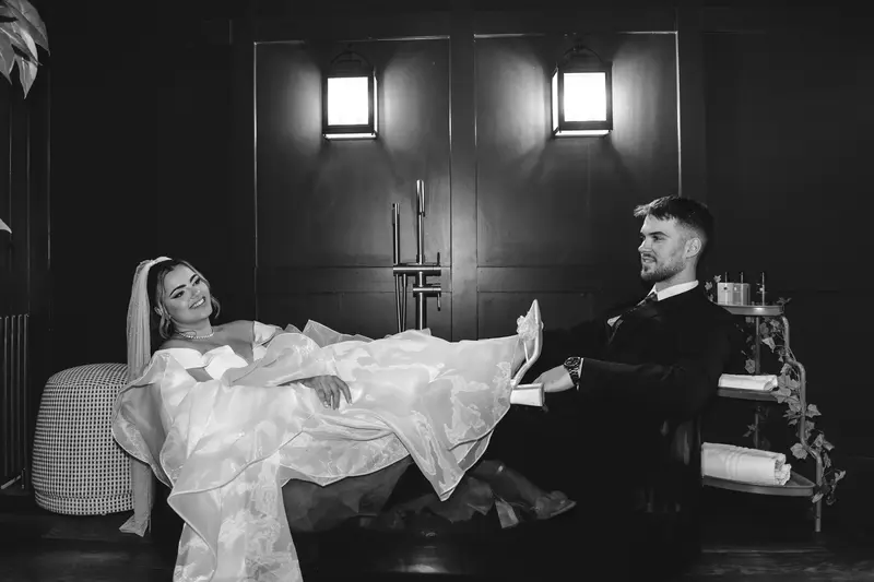 Bride and groom relaxing together in a stylish lounge during creative wedding portraits