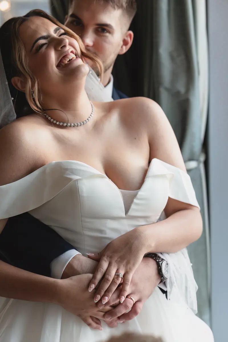 Romantic bride and groom portraits by window in Leeds wedding photography