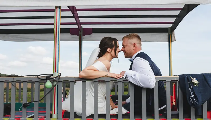Romantic newlywed moment on vintage wedding carriage ride
