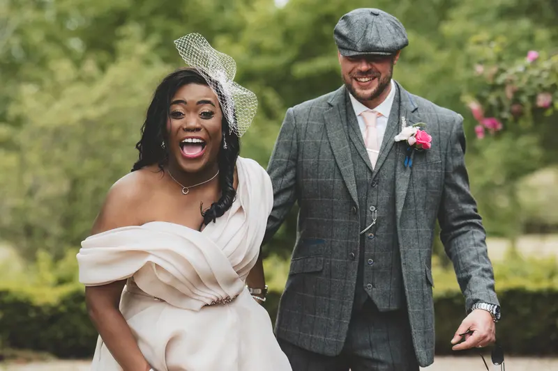 Bride laughing beside the groom during joyful documentary wedding portraits
