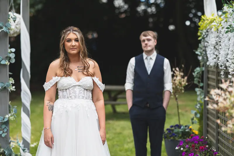 Bride and groom standing together outside the wedding venue after the ceremony
