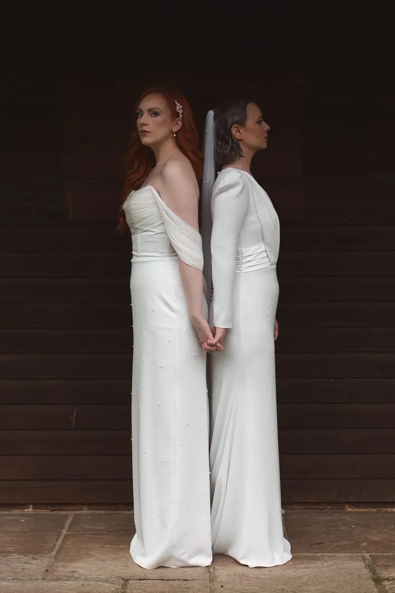 Romantic lesbian wedding couple holding hands in cinematic Yorkshire portrait