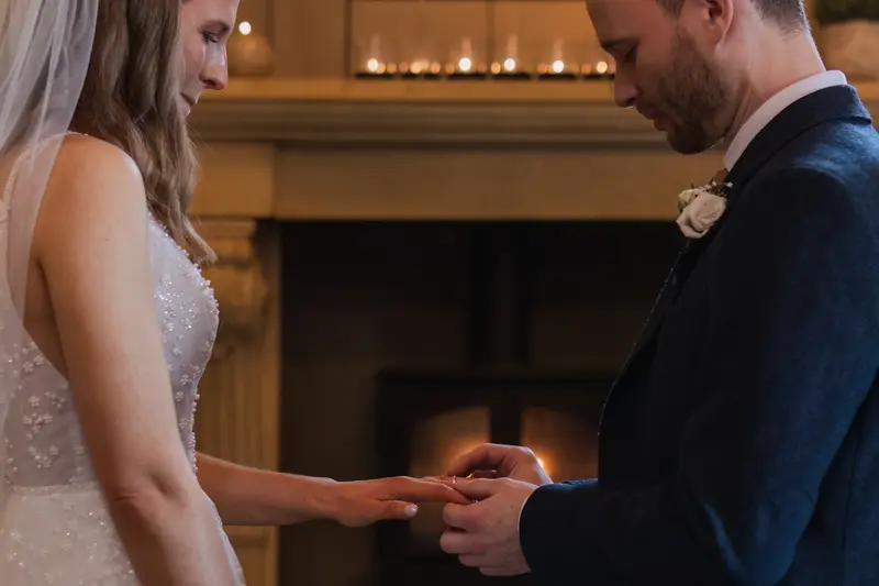 Romantic wedding ring exchange by candlelight at Yorkshire wedding venue