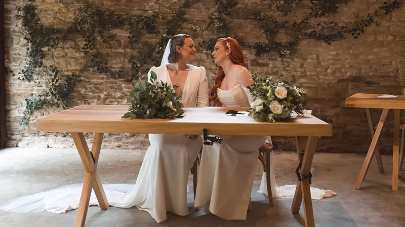 Lesbian wedding couple portrait during intimate ceremony signing