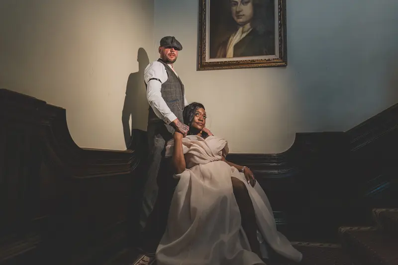 Creative wedding portrait of bride and groom on a historic staircase