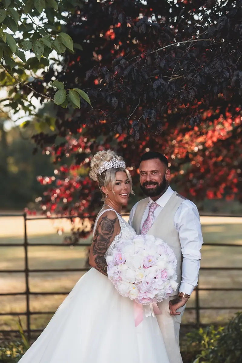 Romantic bride and groom portrait under red tree, luxury wedding photography Yorkshire