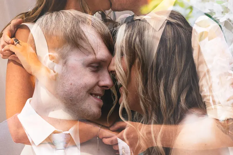 Double exposure close up of the bride and groom sharing an intimate moment