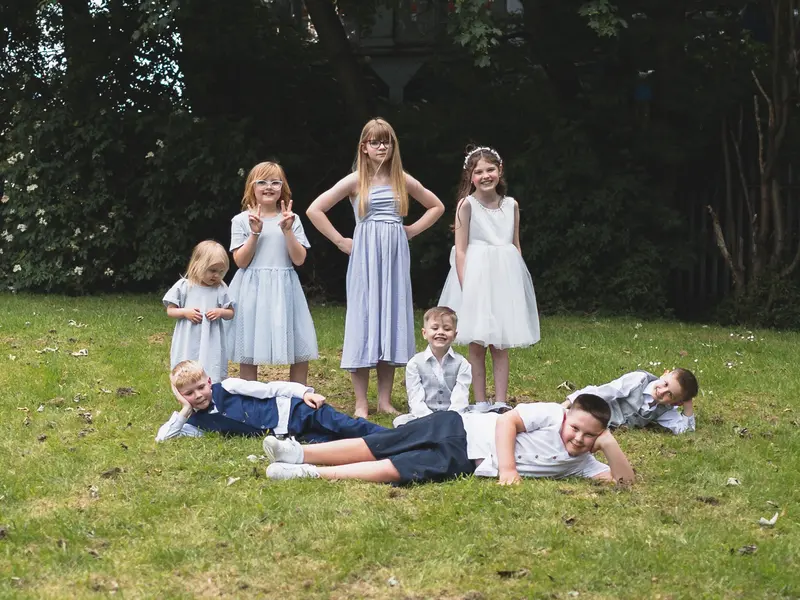 Fun bridal party lying on the grass during creative wedding photography