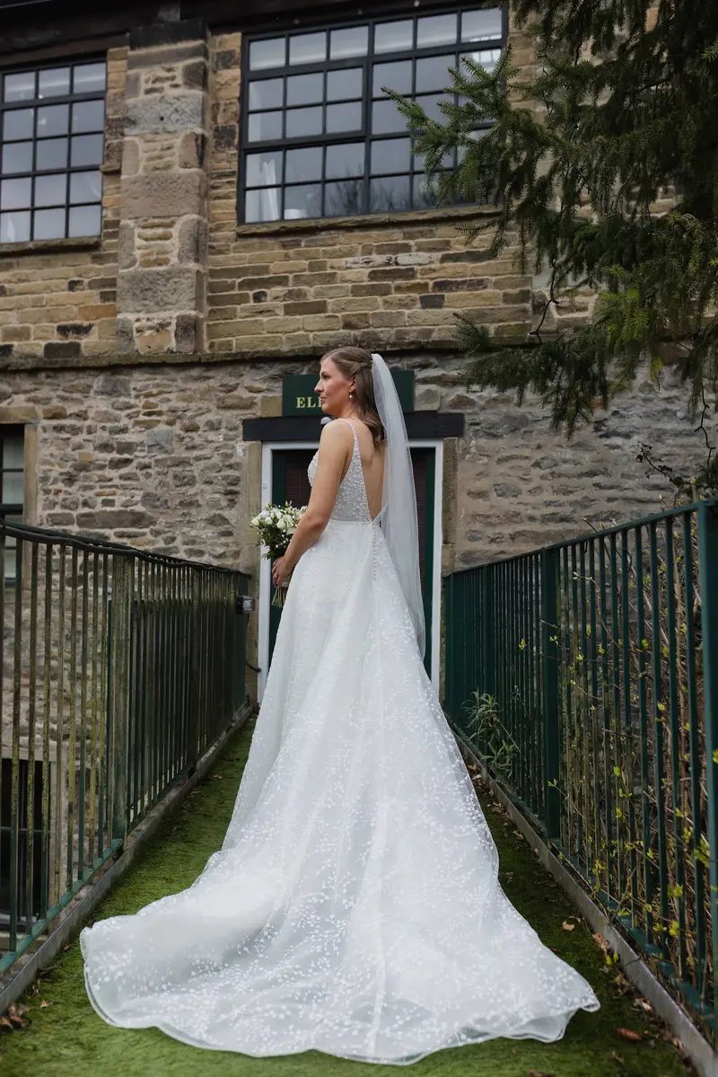 Cinematic bridal portrait outside rustic Yorkshire wedding venue