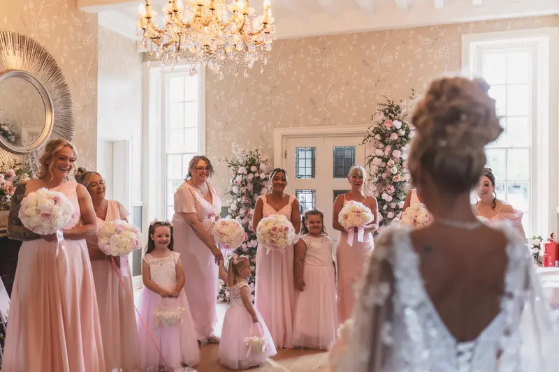 Bridesmaids reaction to bride reveal during luxury wedding preparations