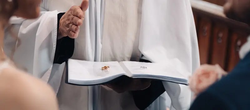 Close up wedding rings exchange during church ceremony photographed in Yorkshire