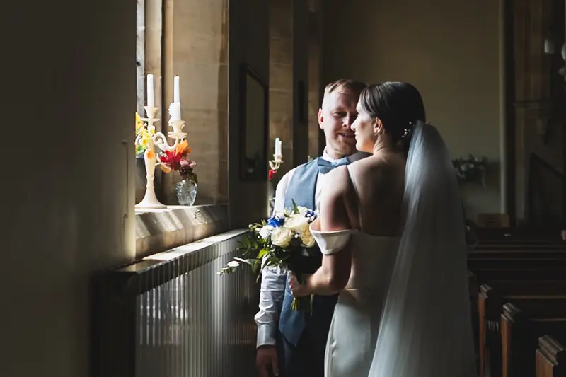 Romantic bride and groom portrait inside Yorkshire church ceremony venue