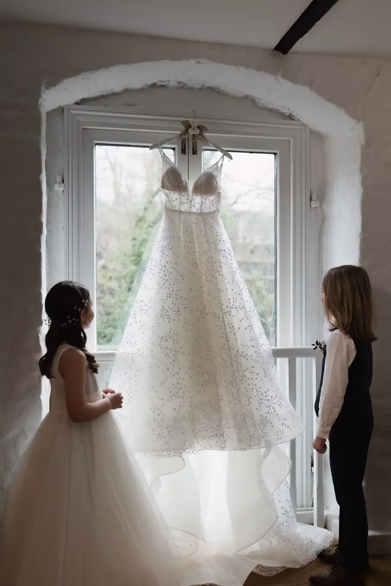 Candid flower girl and page boy admiring wedding dress at Yorkshire documentary wedding