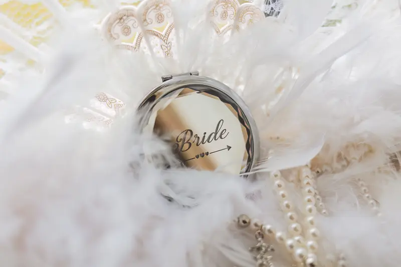 Close up wedding detail of bride jewellery and personalised bride keepsake