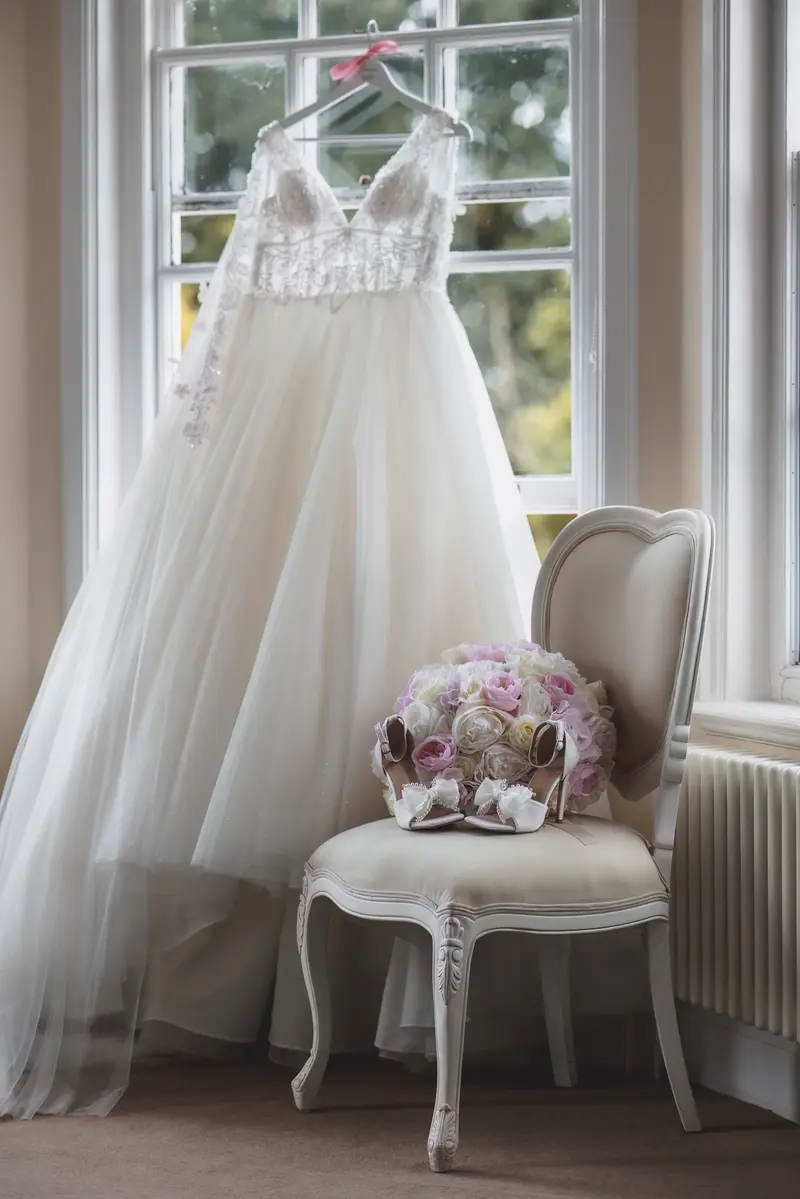Bridal dress and bouquet by window, romantic bridal preparation photography, luxury wedding morning