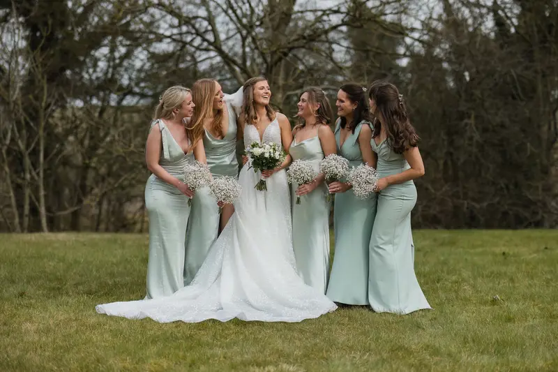 Candid bridesmaids laughing with bride during Yorkshire countryside wedding photography