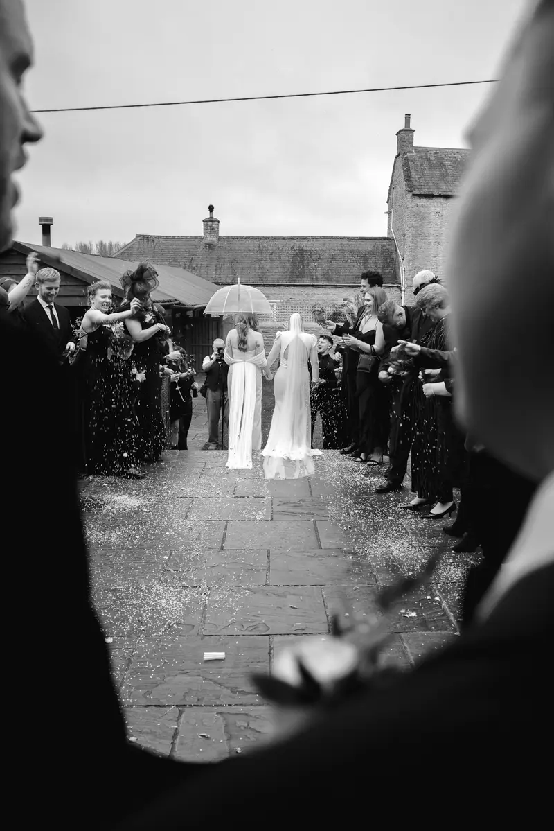 Black and white confetti exit same sex wedding