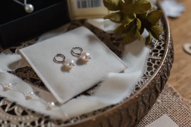 Moody wedding jewellery detail photo with pearl earrings and bridal accessories in Yorkshire
