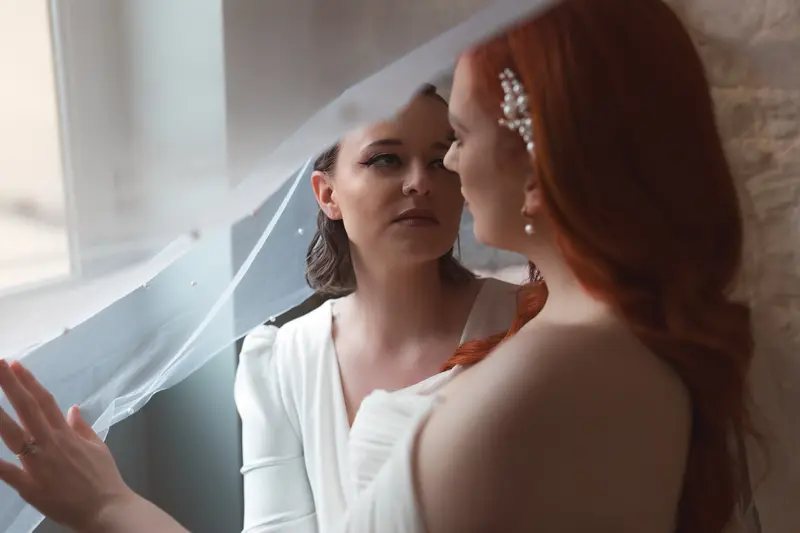Emotional bridal portrait under veil with soft documentary wedding photography