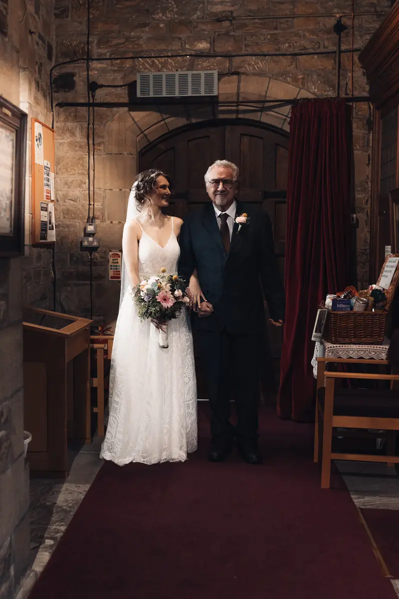 Emotional bride entrance with father captured by Yorkshire documentary wedding photographer