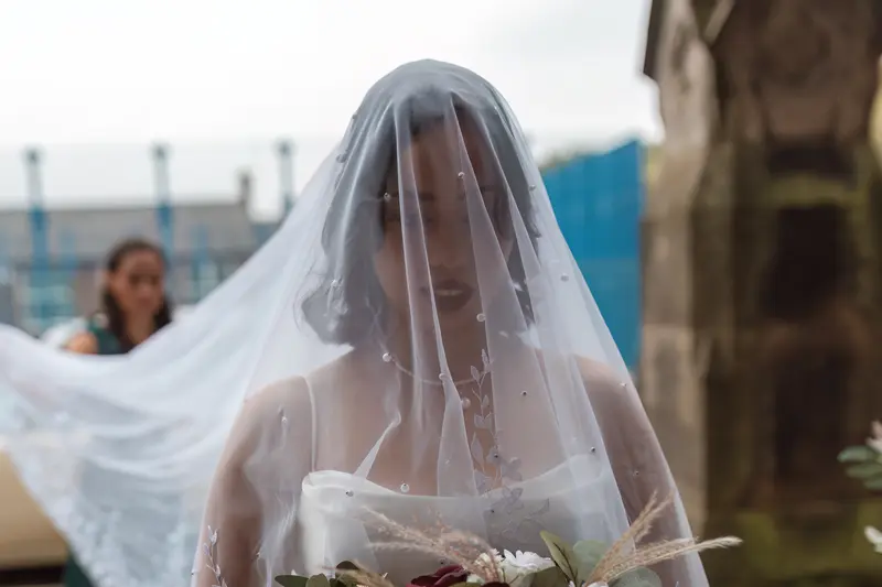 Natural documentary wedding photography Yorkshire bride walking with veil before ceremony