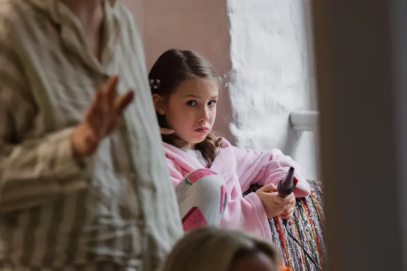 Documentary wedding morning preparation photo of flower girl during bridal prep in Yorkshire wedding venue