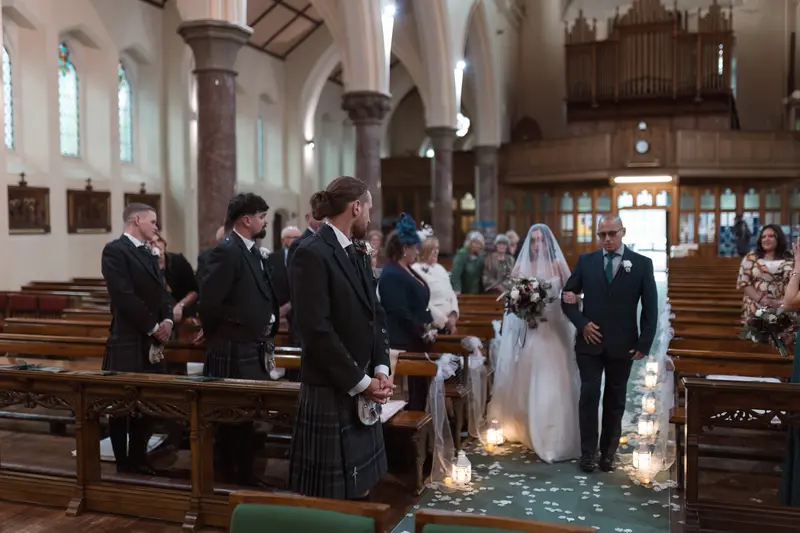 Emotional bridal entrance at Yorkshire church wedding with candid documentary photography style