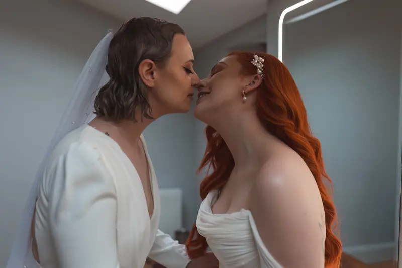 Intimate bridal couple portrait with champagne during wedding morning