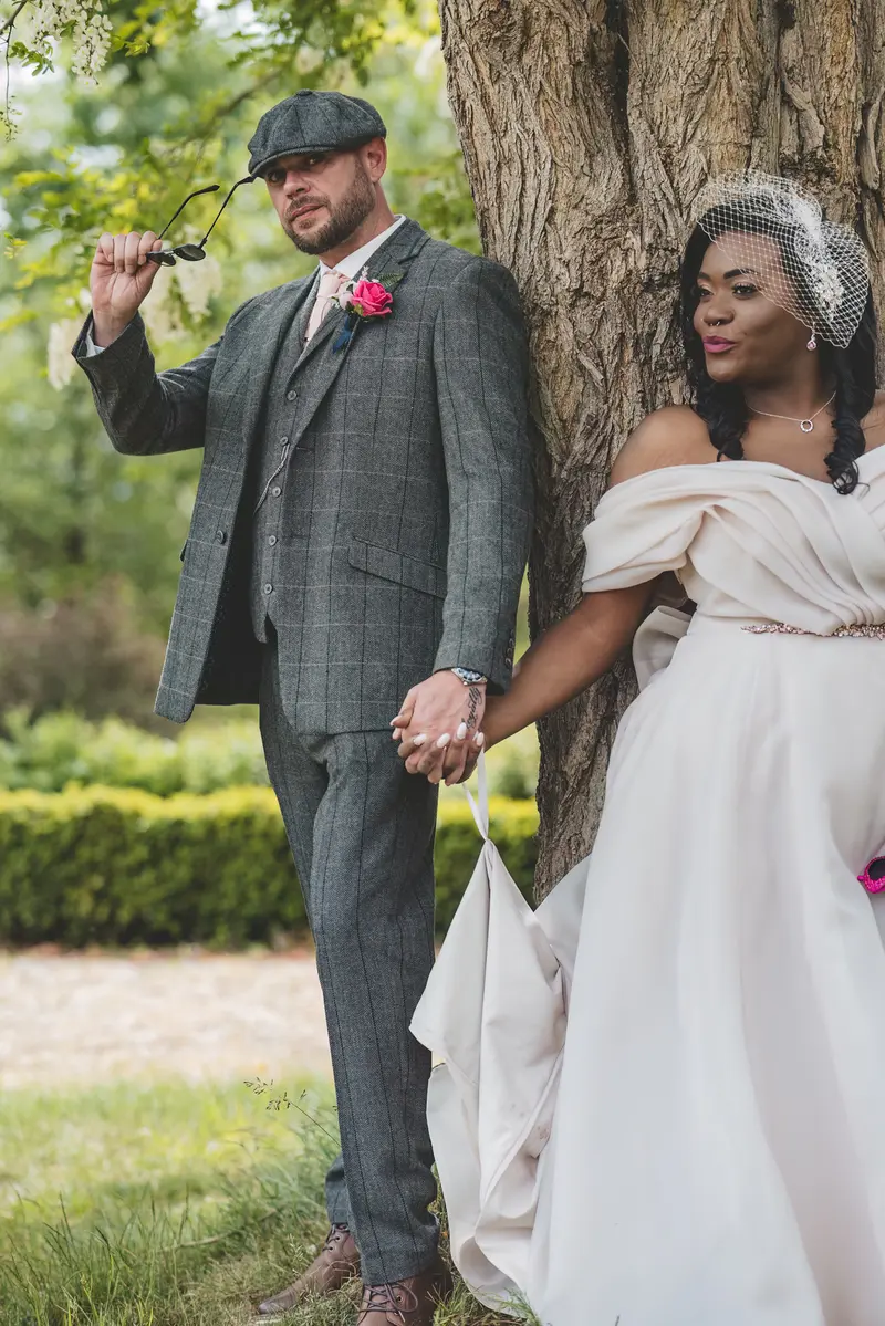 Bride and groom walking together through the garden during documentary wedding portraits