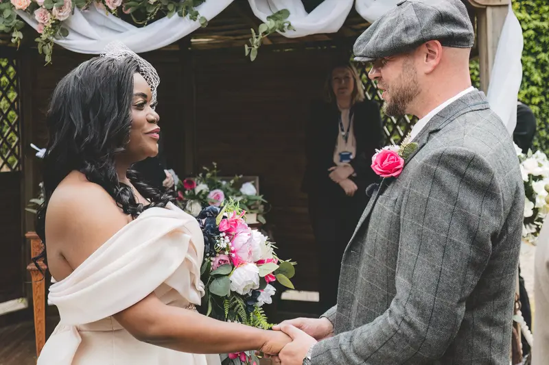 Bride and groom exchanging vows outdoors during a natural documentary wedding ceremony