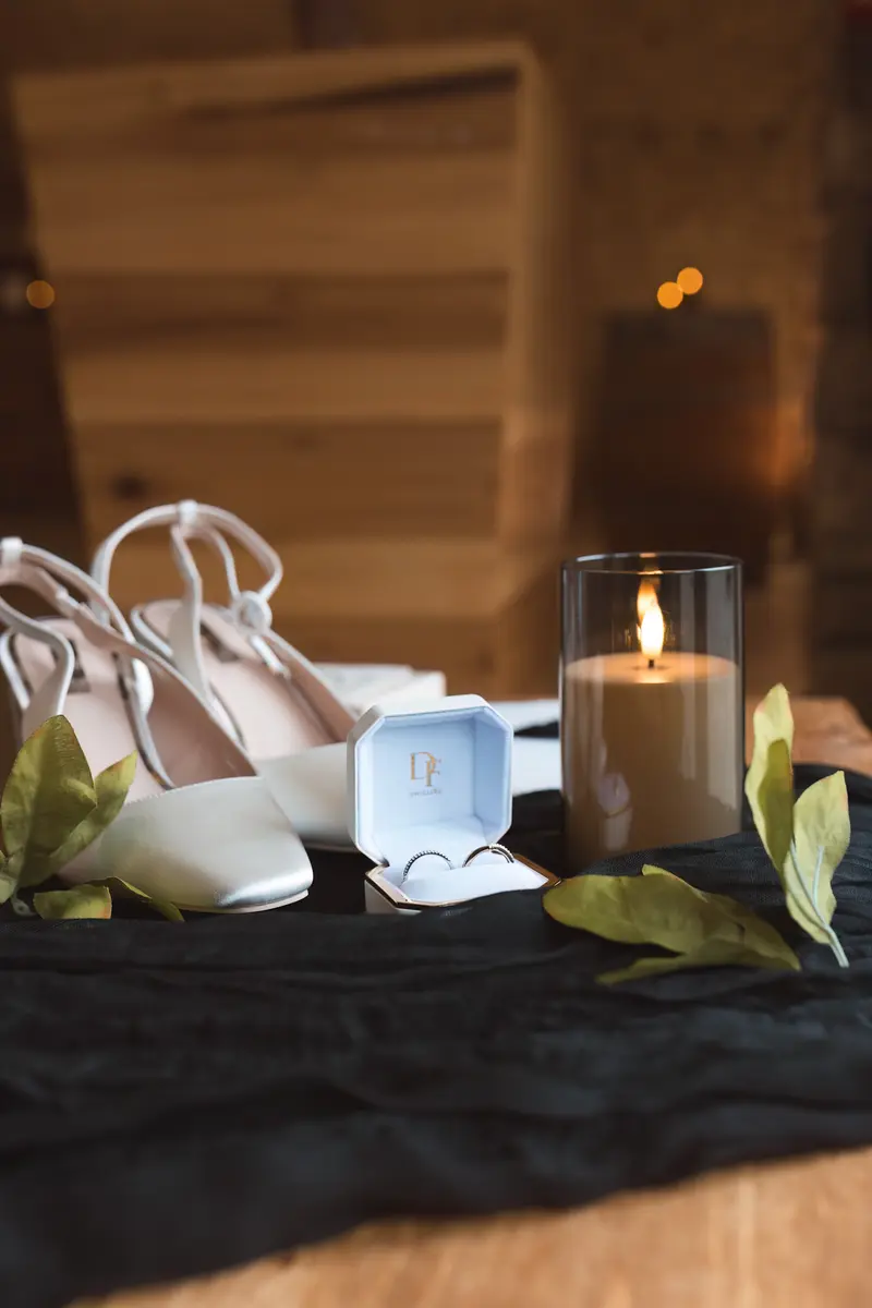 Luxury wedding ring detail shot with candlelight styling
