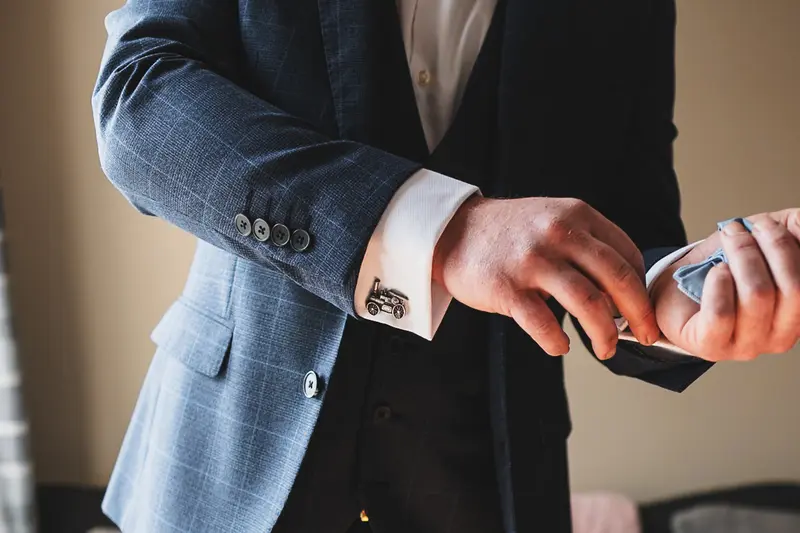Groom adjusting cufflinks during wedding morning preparations in Yorkshire