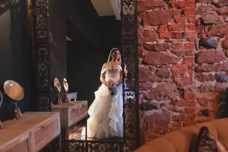 Elegant bridal portrait reflected in a mirror during wedding morning preparations