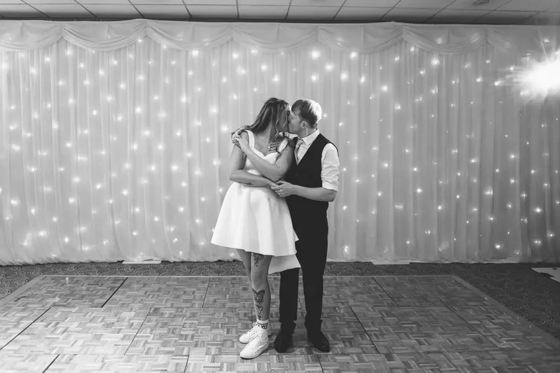 Black and white first dance photograph with romantic wedding lighting